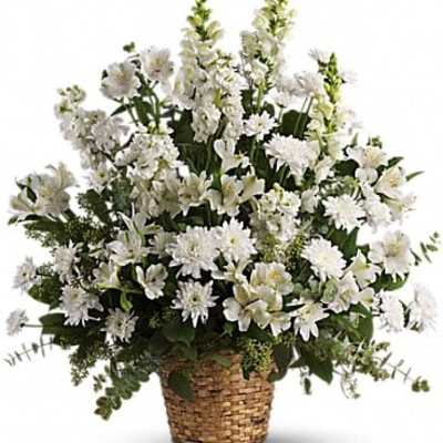 White floral arrangement in a woven basket