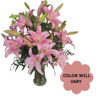 Pink lilies arranged in a clear glass vase