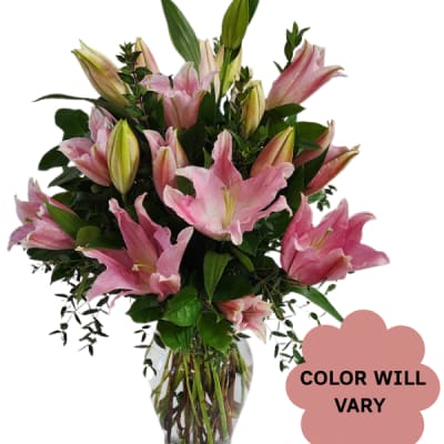 Pink lilies arranged in a clear glass vase