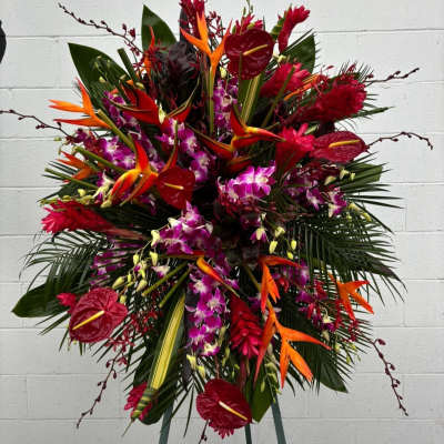 Large tropical floral spray with red anthuriums, orchids, and orange bird of paradise