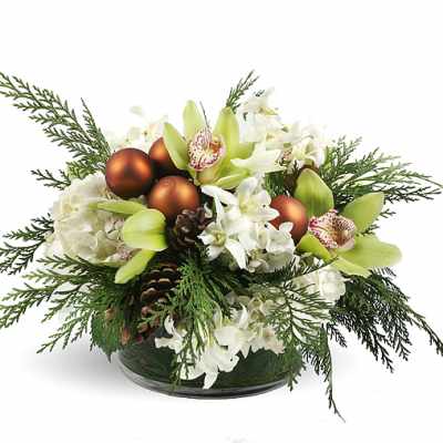 White flowers and green orchids in a low glass bowl with pinecones and copper ornaments