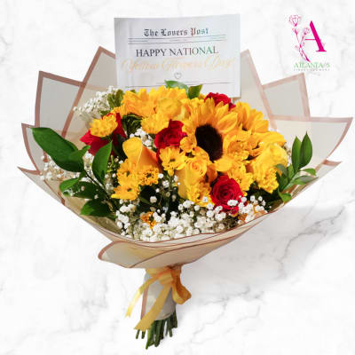 Bouquet of yellow sunflowers and red roses wrapped in paper