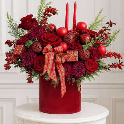 Red roses and candles in a velvet box with a plaid bow