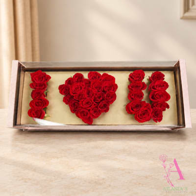 Red roses arranged to spell "I ♥ U" in a rectangular box