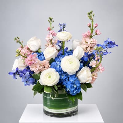 Blue and white floral arrangement in a glass vase