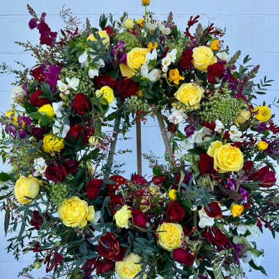 Large floral wreath with yellow, red, white, and purple flowers