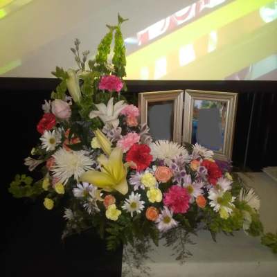 Large mixed floral arrangement with lilies, daisies, and carnations