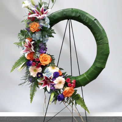 Floral standing wreath with mixed blooms on an easel