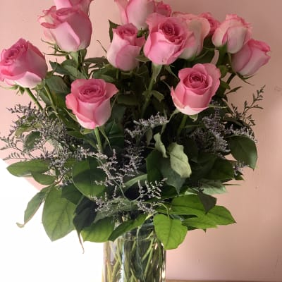 Pink roses arranged in a clear glass vase