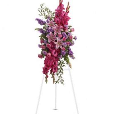 Tall standing floral spray with pink and purple flowers on an easel