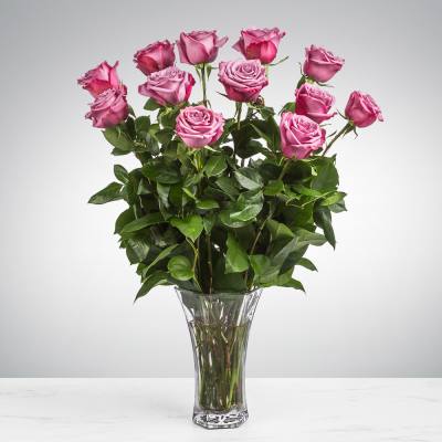 Pink roses arranged in a clear glass vase