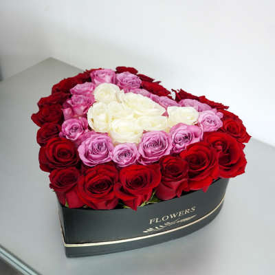 Heart-shaped box of red, pink, and white roses