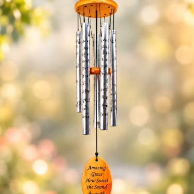 Silver wind chime with an orange top and hanging plaque