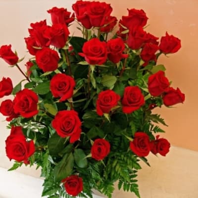 Tall bouquet of red roses with greenery