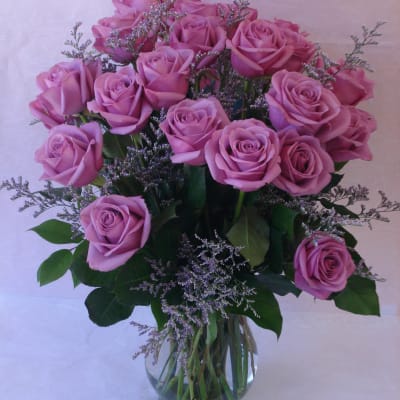 Pink roses arranged in a clear glass vase