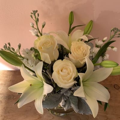 White roses and lilies in a glass vase