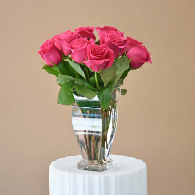 Pink roses arranged in a clear glass vase
