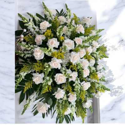 Large white rose arrangement with green and yellow accents