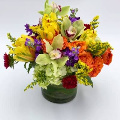Colorful mixed bouquet in a green glass vase