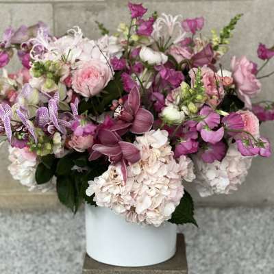 Pink and white mixed flower arrangement in a white vase
