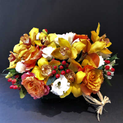 Bouquet of yellow orchids and orange roses with red berries