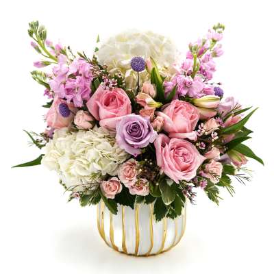 Pink and white flower arrangement in a striped ceramic vase