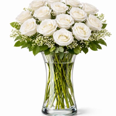 White roses arranged in a clear glass vase