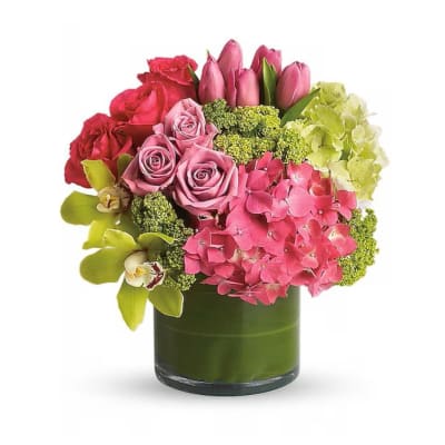 Pink and red flower arrangement in a green vase