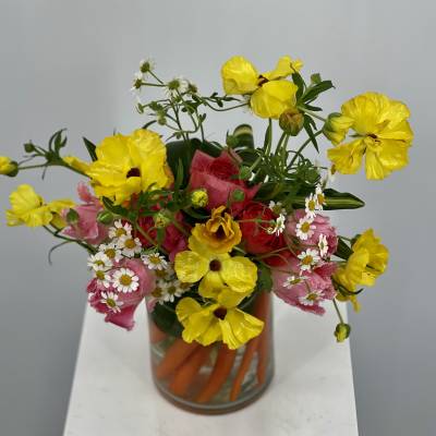 Bouquet of yellow and pink flowers in a glass vase