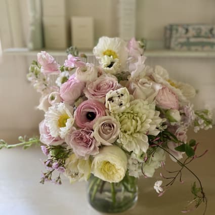 Soft pink and white bouquet in a glass vase
