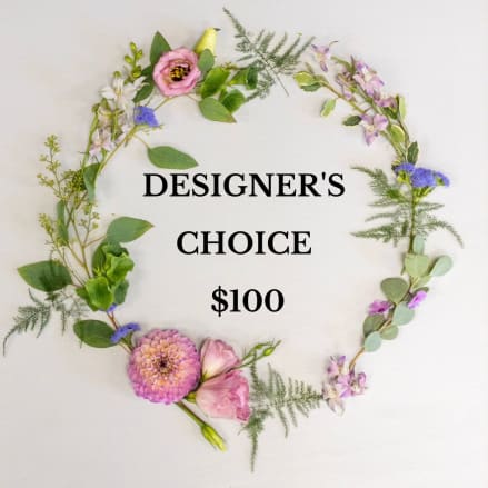 Flat-lay wreath of pastel flowers surrounding text reading “DESIGNER'S CHOICE $100”.