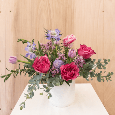 Pink and lavender mixed bouquet in a white vase