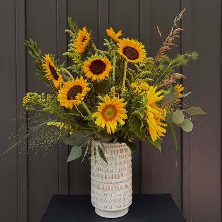 Sunflower arrangement in a patterned ceramic vase