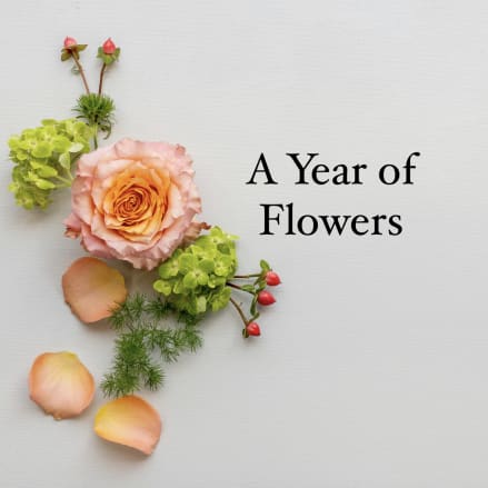 Peach rose with green blooms and petals arranged beside the words A Year of Flowers on a light background