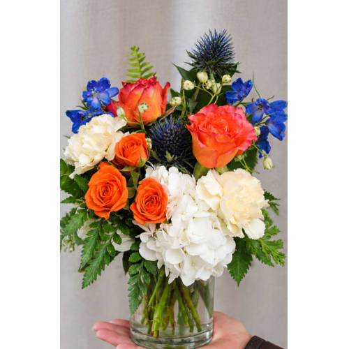 Bouquet of orange and white flowers in a clear glass vase