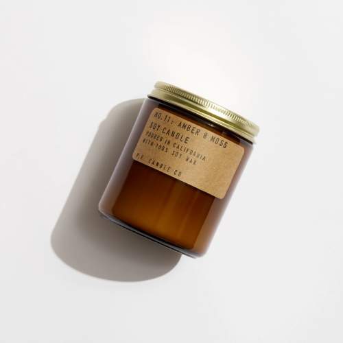 Amber soy candle in a glass jar with a gold lid