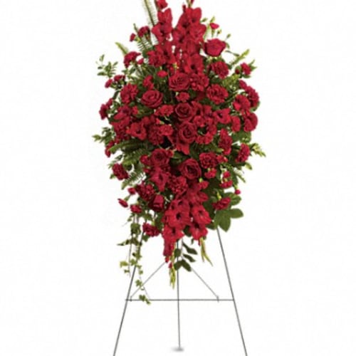 Standing spray of red flowers on a metal easel