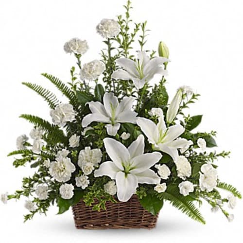 White lilies and carnations in a wicker basket