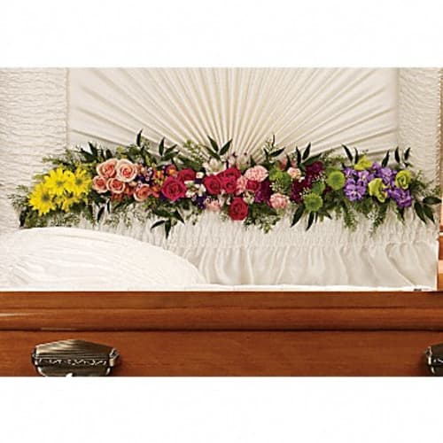 Colorful flower spray arranged on a casket