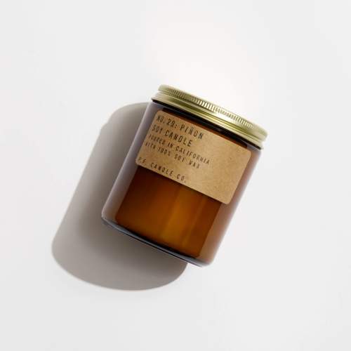 Amber soy candle in a glass jar with a gold lid