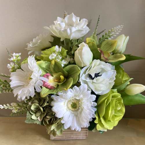 White and lime-green floral arrangement in a wooden box
