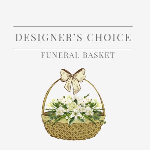 White floral arrangement in a woven basket with a bow