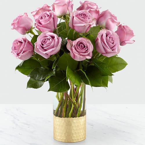Pink roses arranged in a gold-textured vase