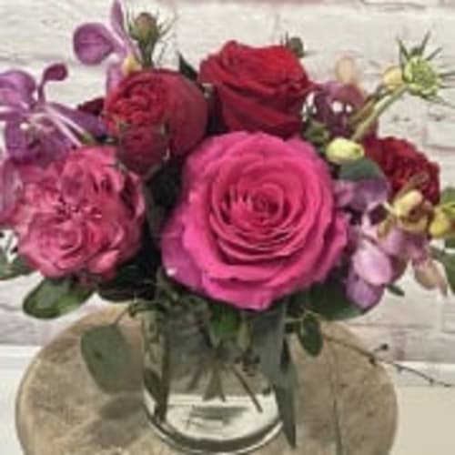 Pink and red rose bouquet in a clear glass vase