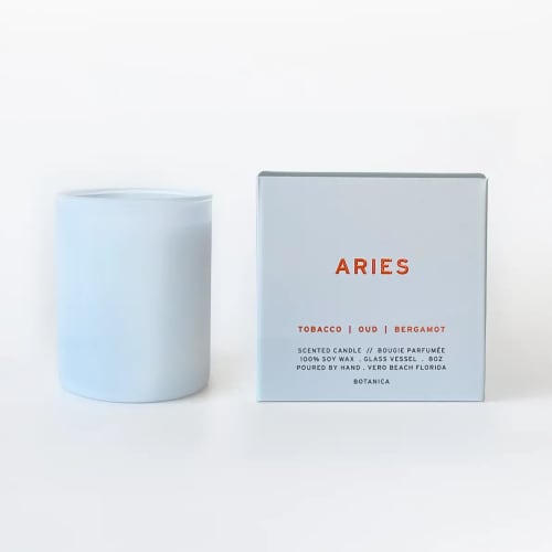 Light blue scented candle beside its matching box