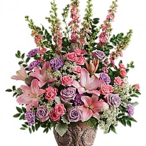 Pink and lavender floral arrangement in a decorative vase