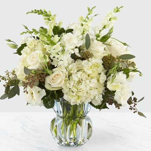 White floral bouquet in a clear glass vase