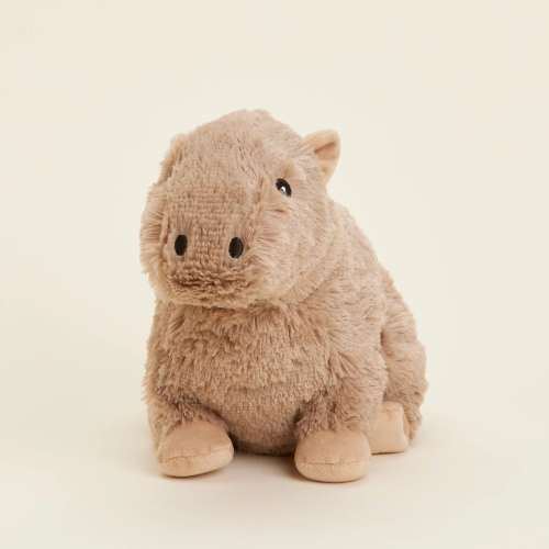 Small tan plush animal toy sitting upright on a light background
