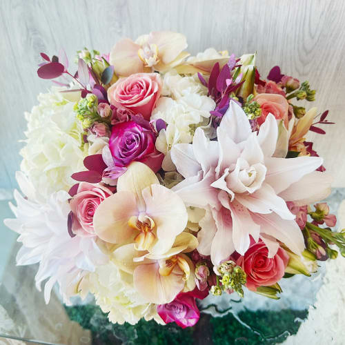 Bouquet of pink roses, white hydrangeas, and pale orchids