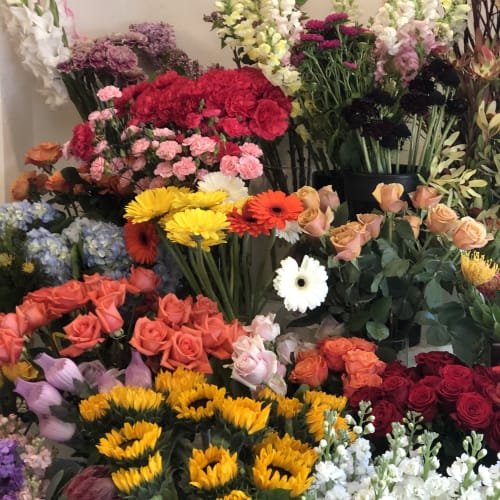 Assorted bouquets of roses, gerbera daisies, and snapdragons in many colors